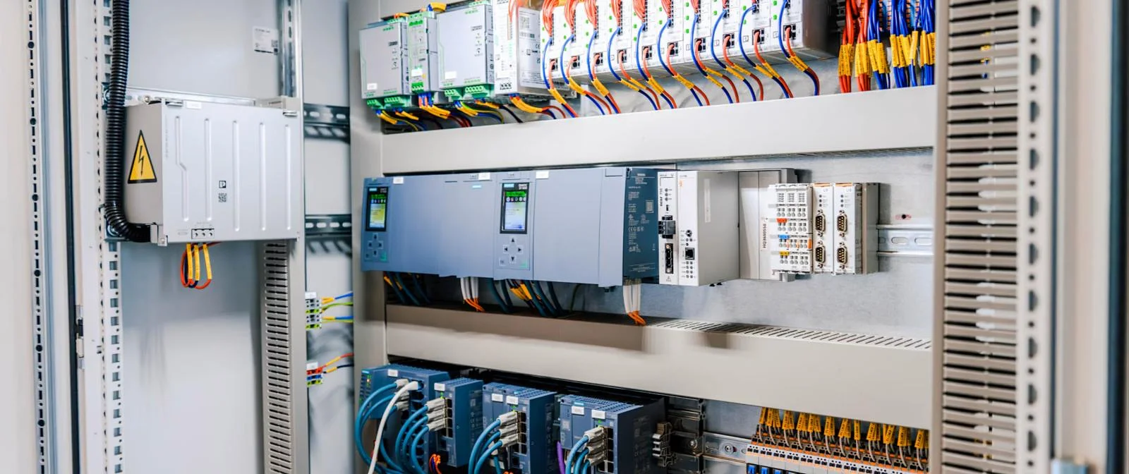 Control panel interior with PLC, power supplies and neatly ferruled wiring