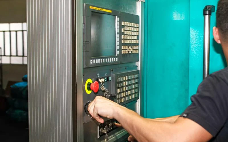 Engineer commissioning a machine at the operator panel