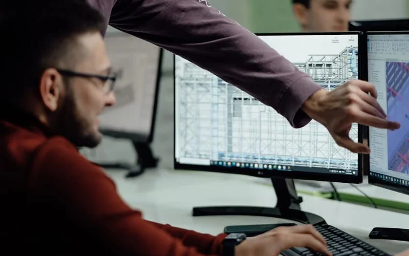 Engineer preparing panel design and technical offer on computer
