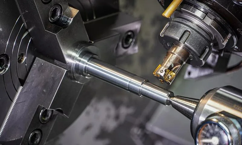 Metal bar being machined in a lathe