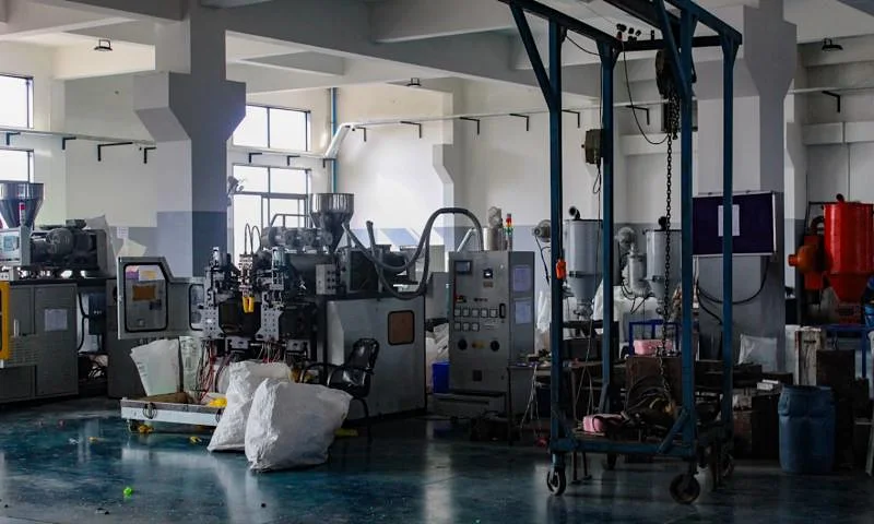 Injection moulding machines on a plastics factory floor